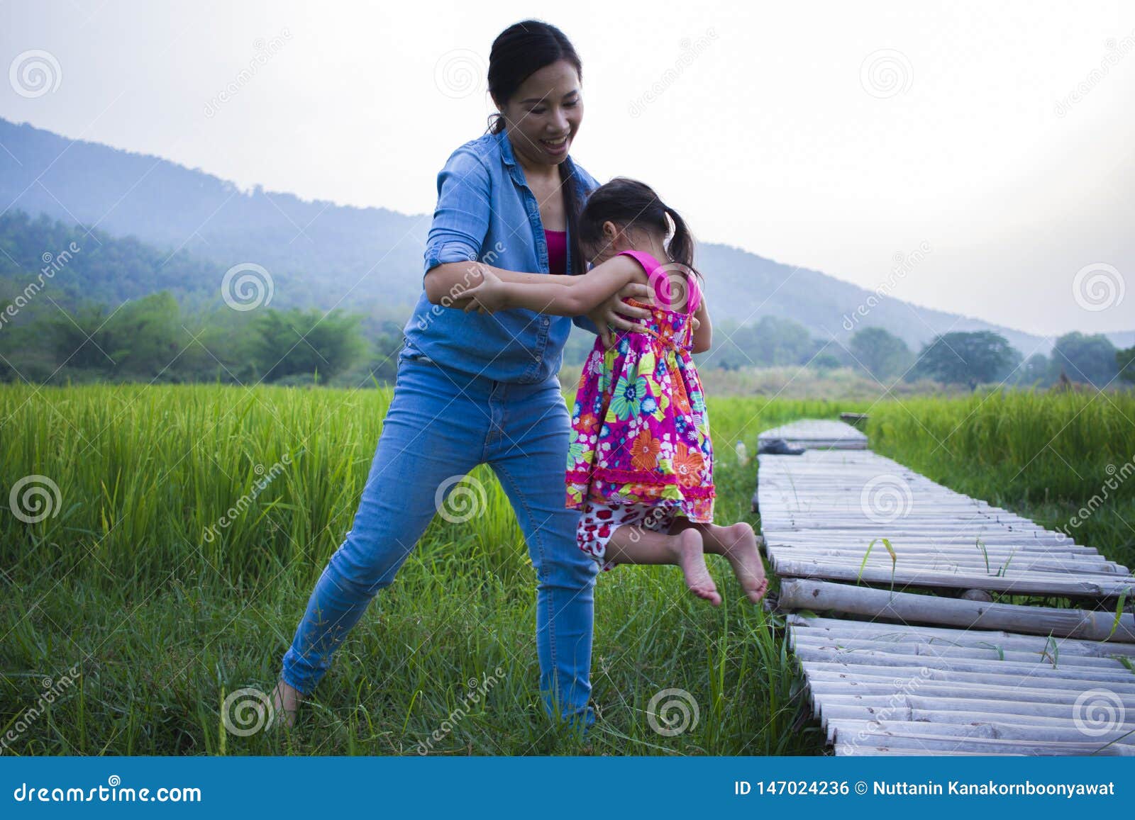 Mother Help Her Child To Cross Stream, Mother Lifting Daughter in R image photo