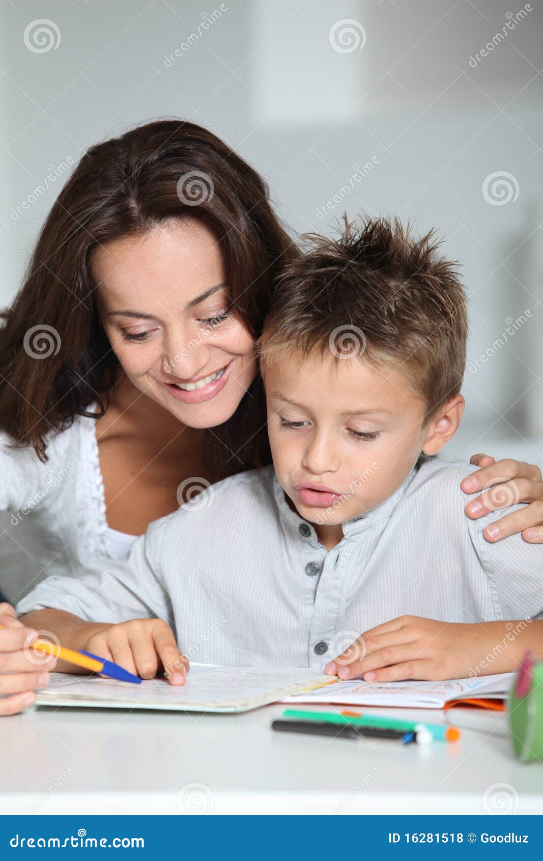 Mother Helping Son In Reading