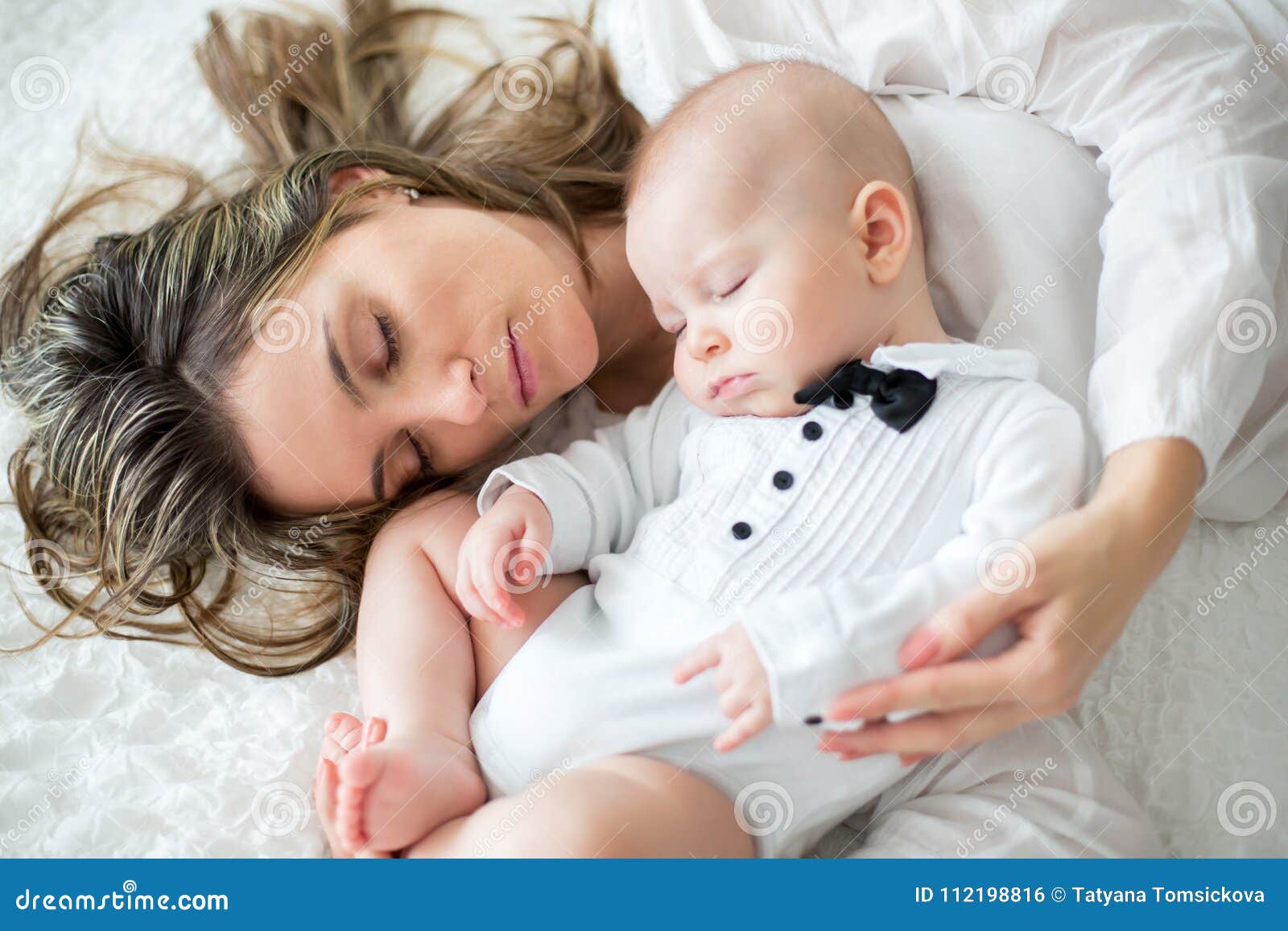 Mother and Her Baby Son, Sleeping on a Big Bed, Soft Back Light ...