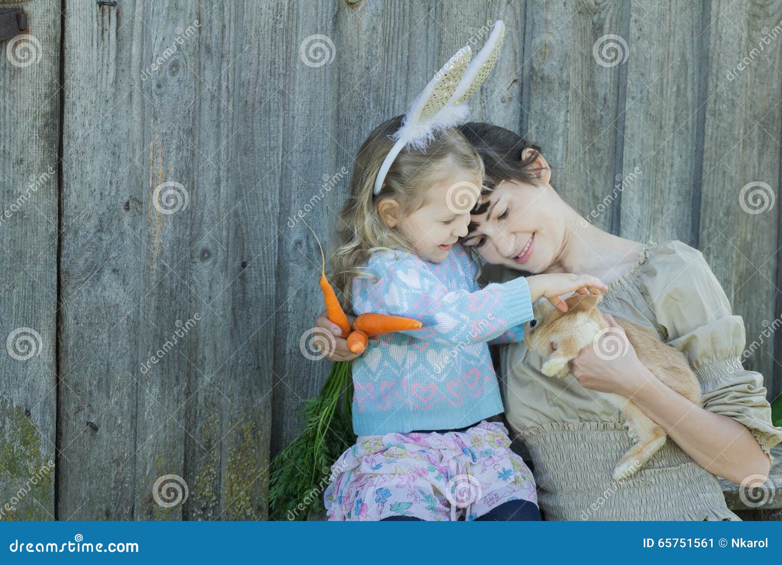Mother and Her Daughter Holding Adorable Little Easter Rabbit Stock