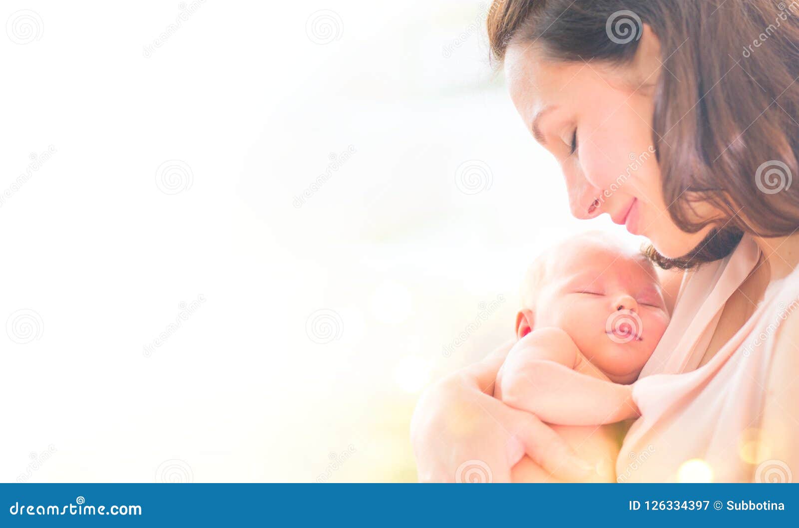 mother and her newborn baby together. happy mother and baby kissing and hugging. maternity concept