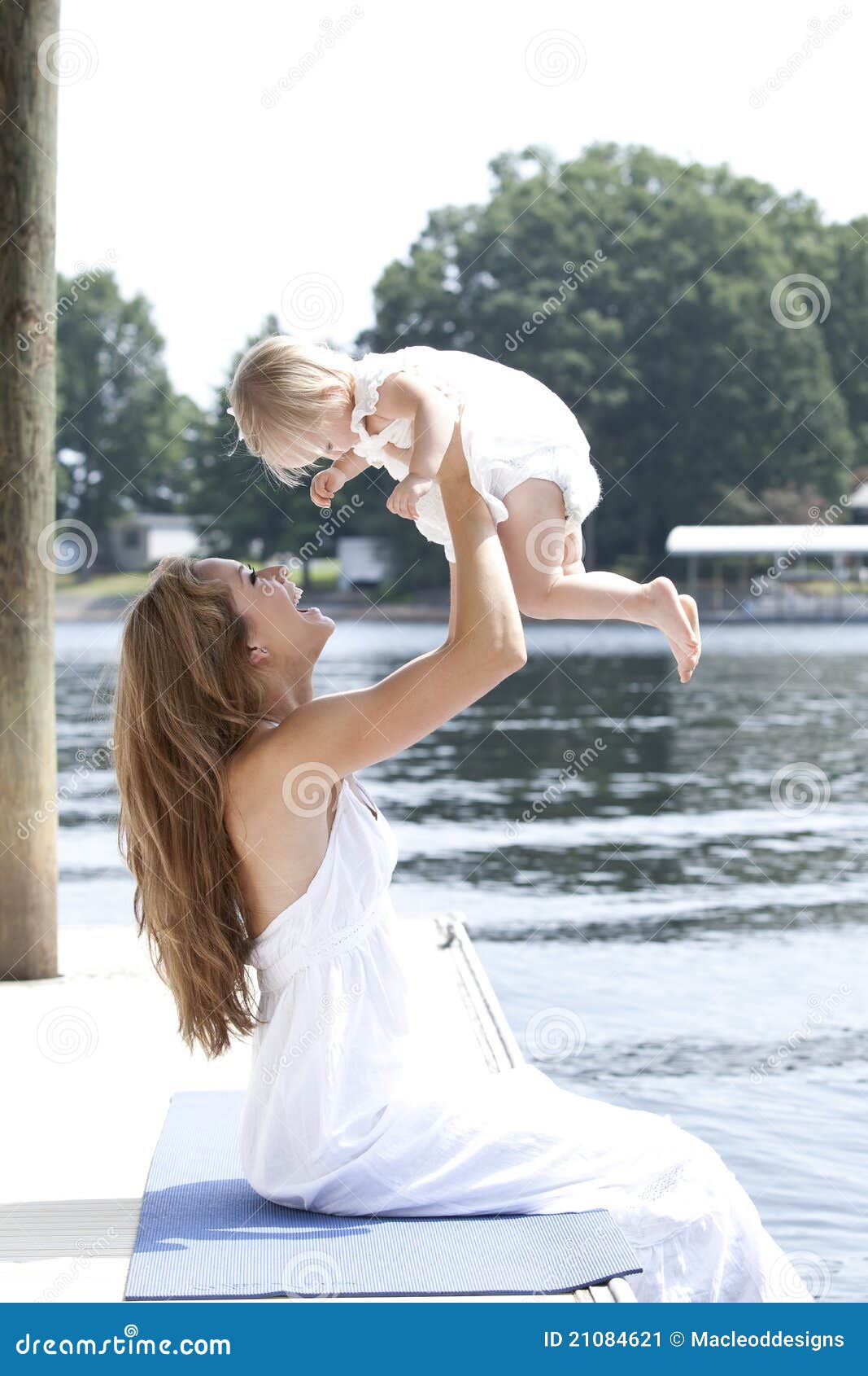 A Mother Holds Her Daughter Playfully In The Air Stock Image Image Of 