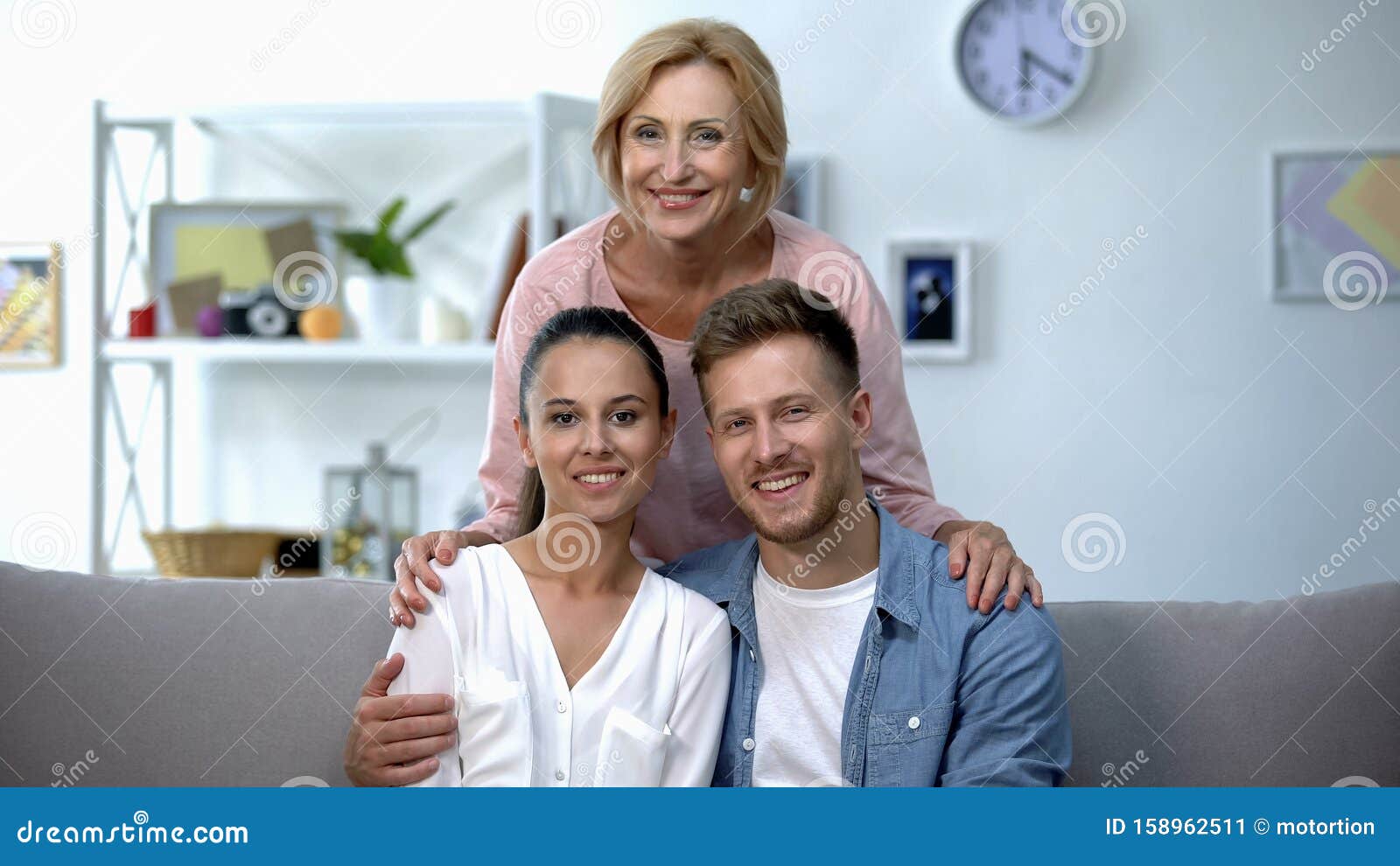 Mother-in-law Embracing Son and His Wife, Happy Family Relationship ... photo