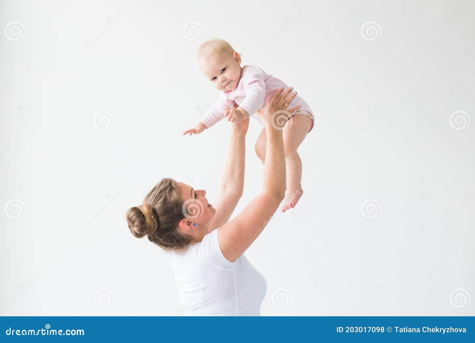 Mother Lifting Baby Girl. Happy Mother Picks Up and Throws His Lifting ...