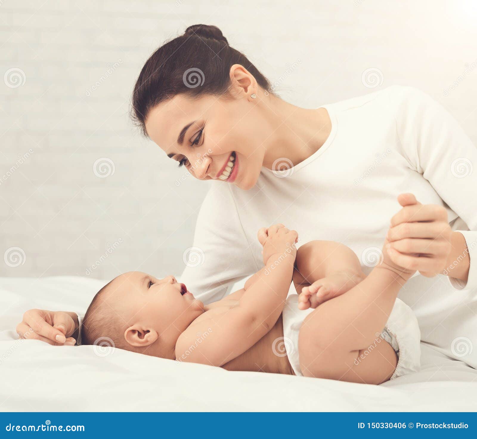 Mother Playing With Her Baby In Bedroom Stock Photo Image