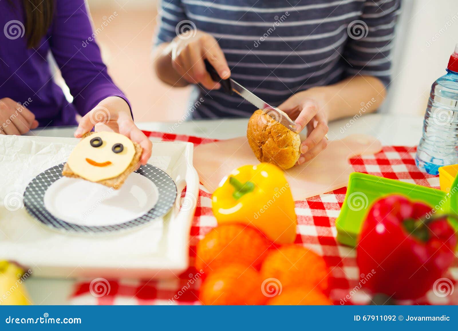 Mother Preparing Healthy And Tasty Lunch Box For Child Stock Photo what-school-lunches-look-like-around-the-world