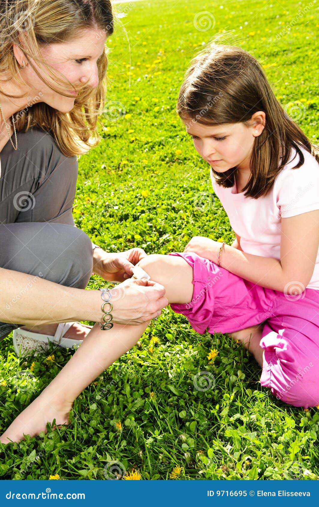 Mother Putting Bandage on Child Stock Image Image of people, lawn