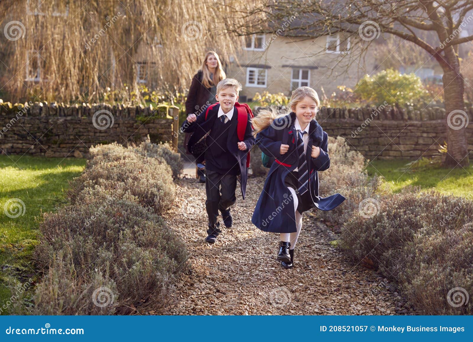 Mother Returning Home from School with Children Wearing School Uniform