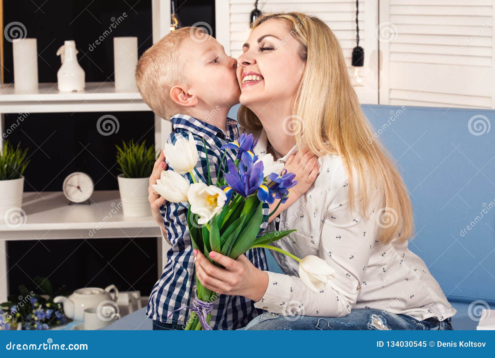 Son Congratulates His Beloved Mother And Gives Her A Bouquet Of Tulips 