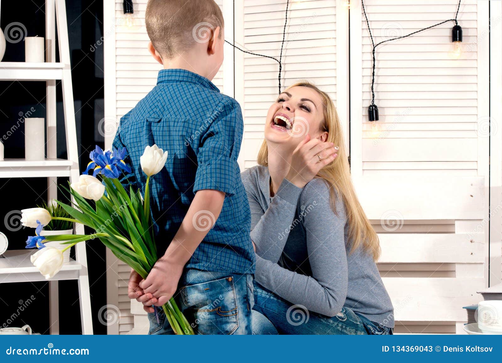 Son Congratulates His Beloved Mother And Gives Her A Bouquet Of Tulips