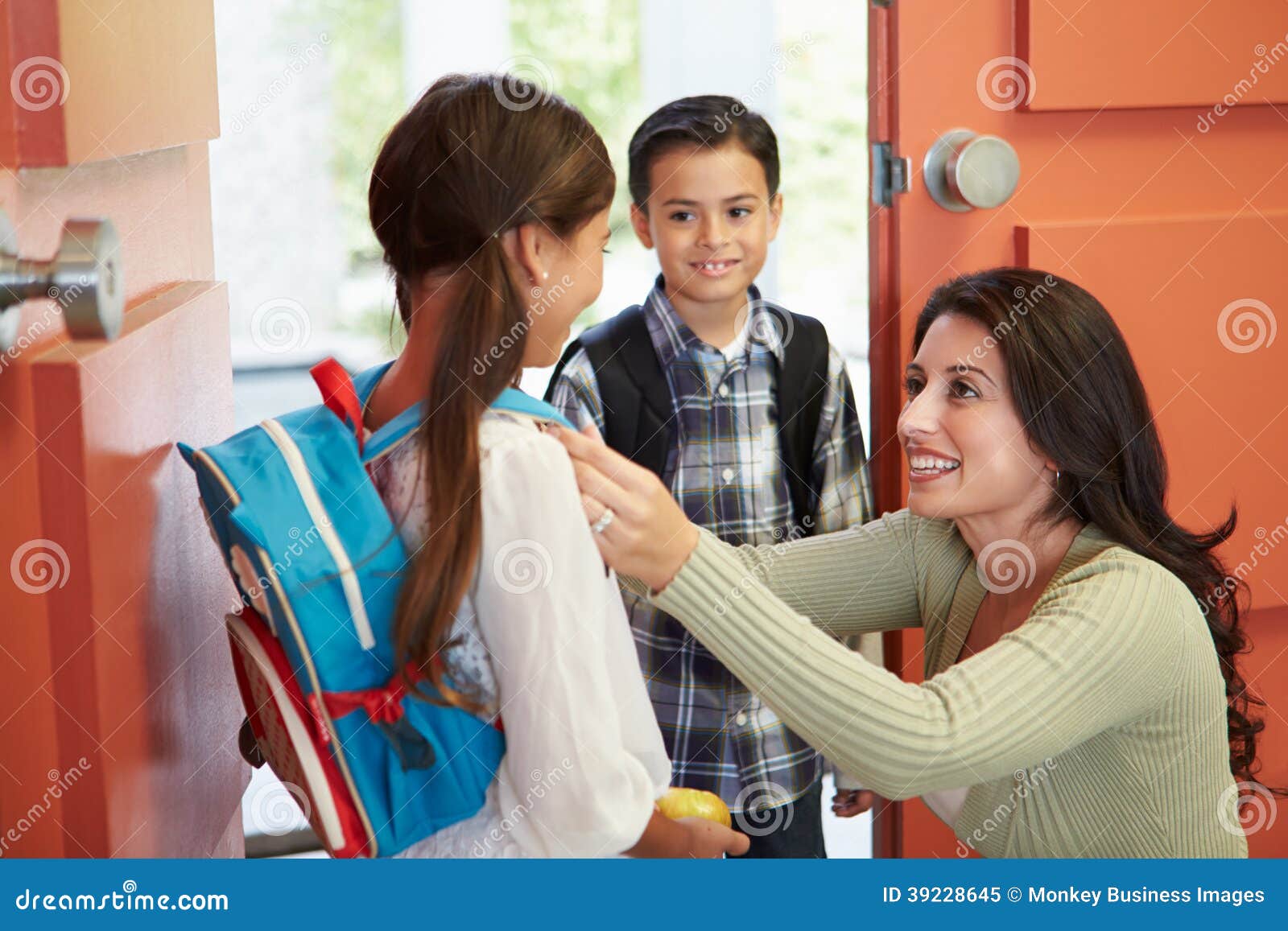 mother saying goodbye to children as they leave for school