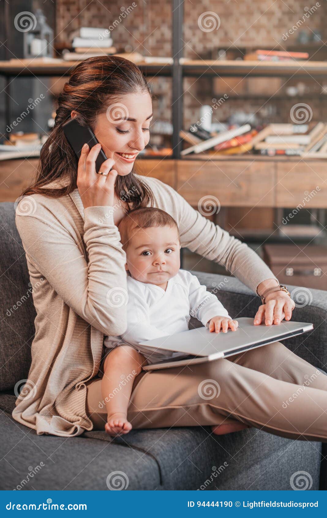 Mother Smiling And Working At Home