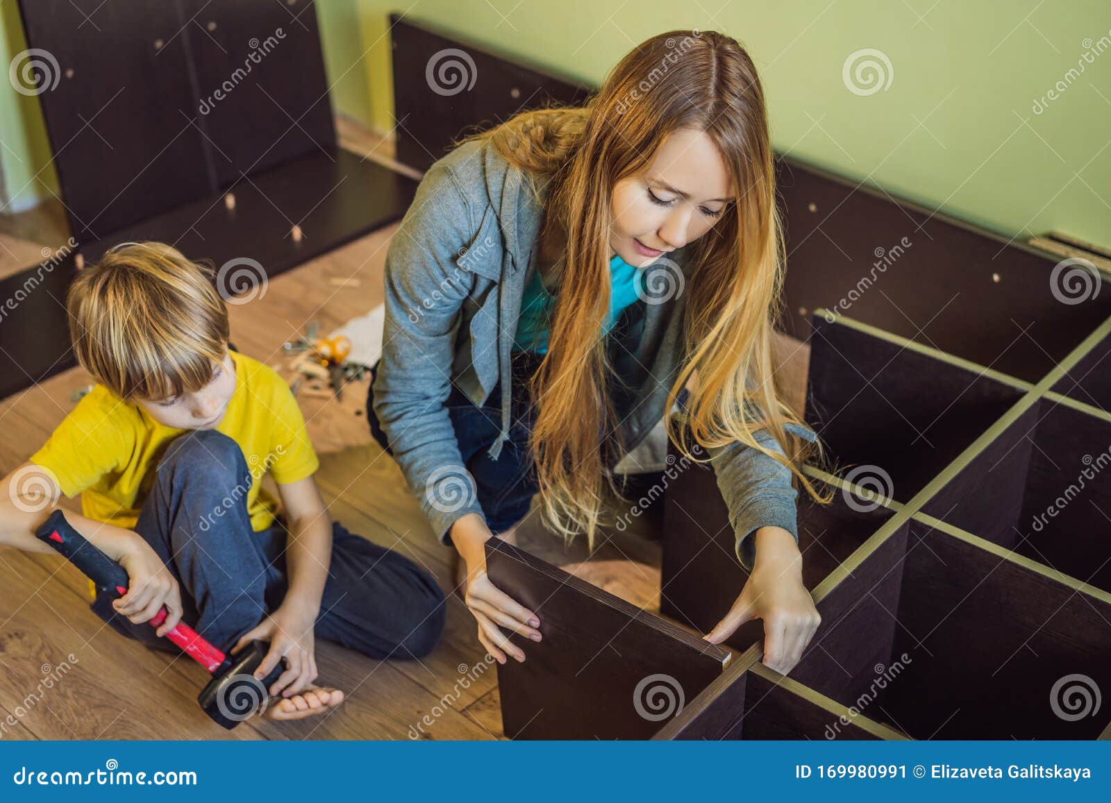 Mother And Son Assembling Furniture Boy Helping His Mom A