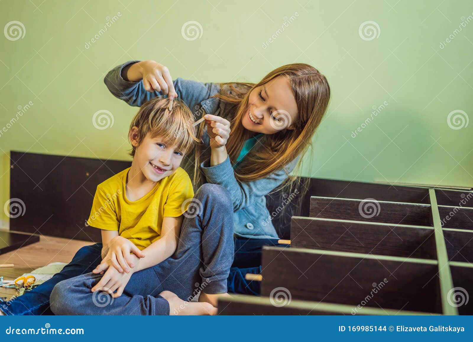 Mother And Son Assembling Furniture Boy Helping His Mom At Home Happ