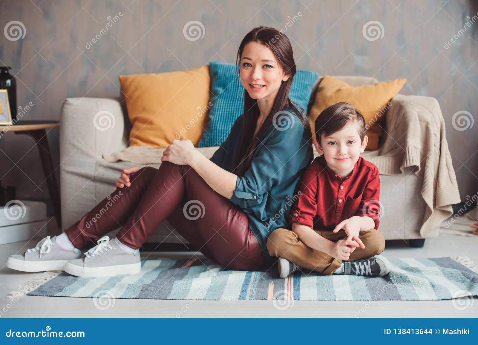 Mother And Son Happy Together At Home Sitting At Cozy Couch Stock