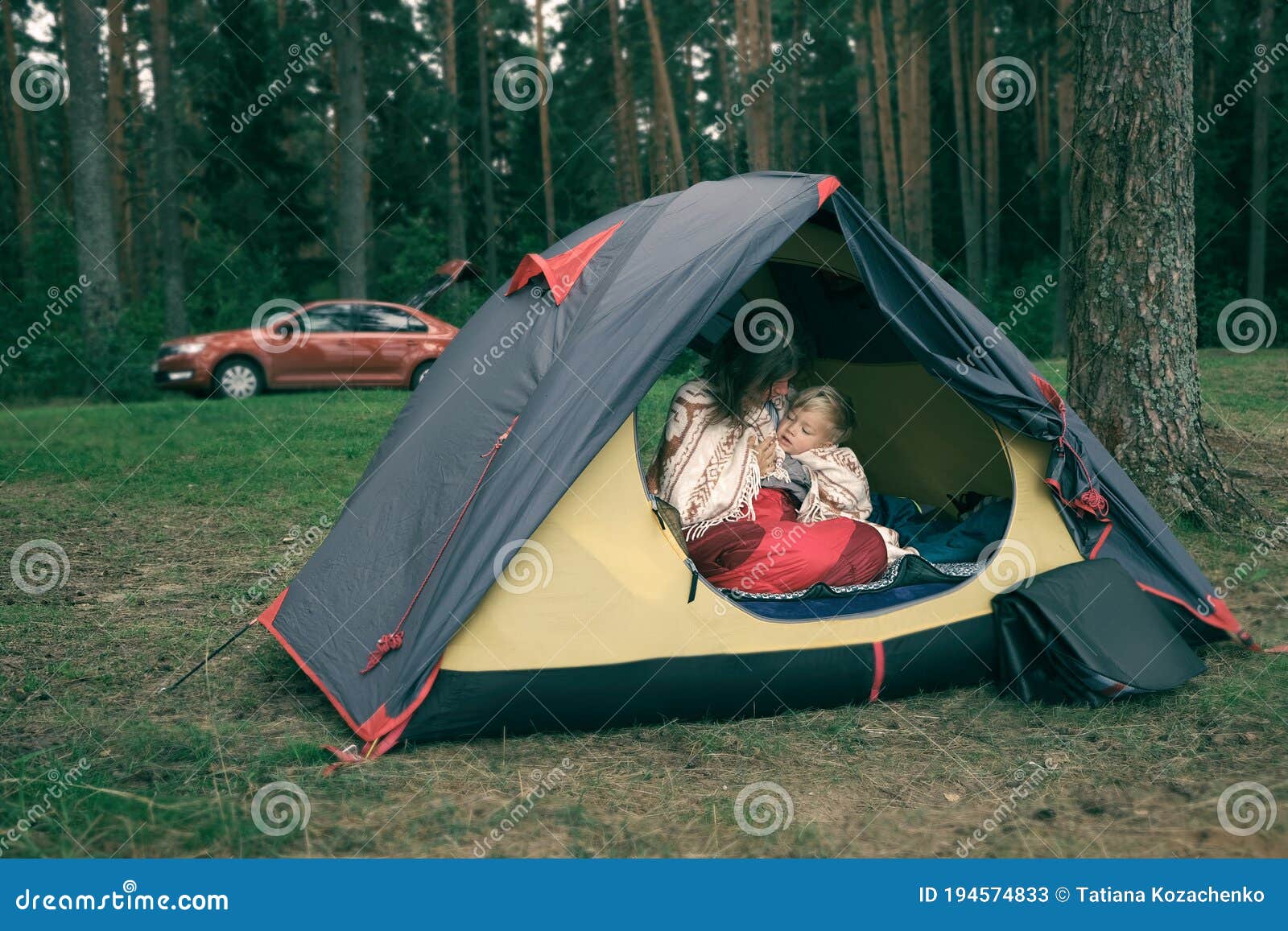 Mother And Son Sitting In Camping Tent