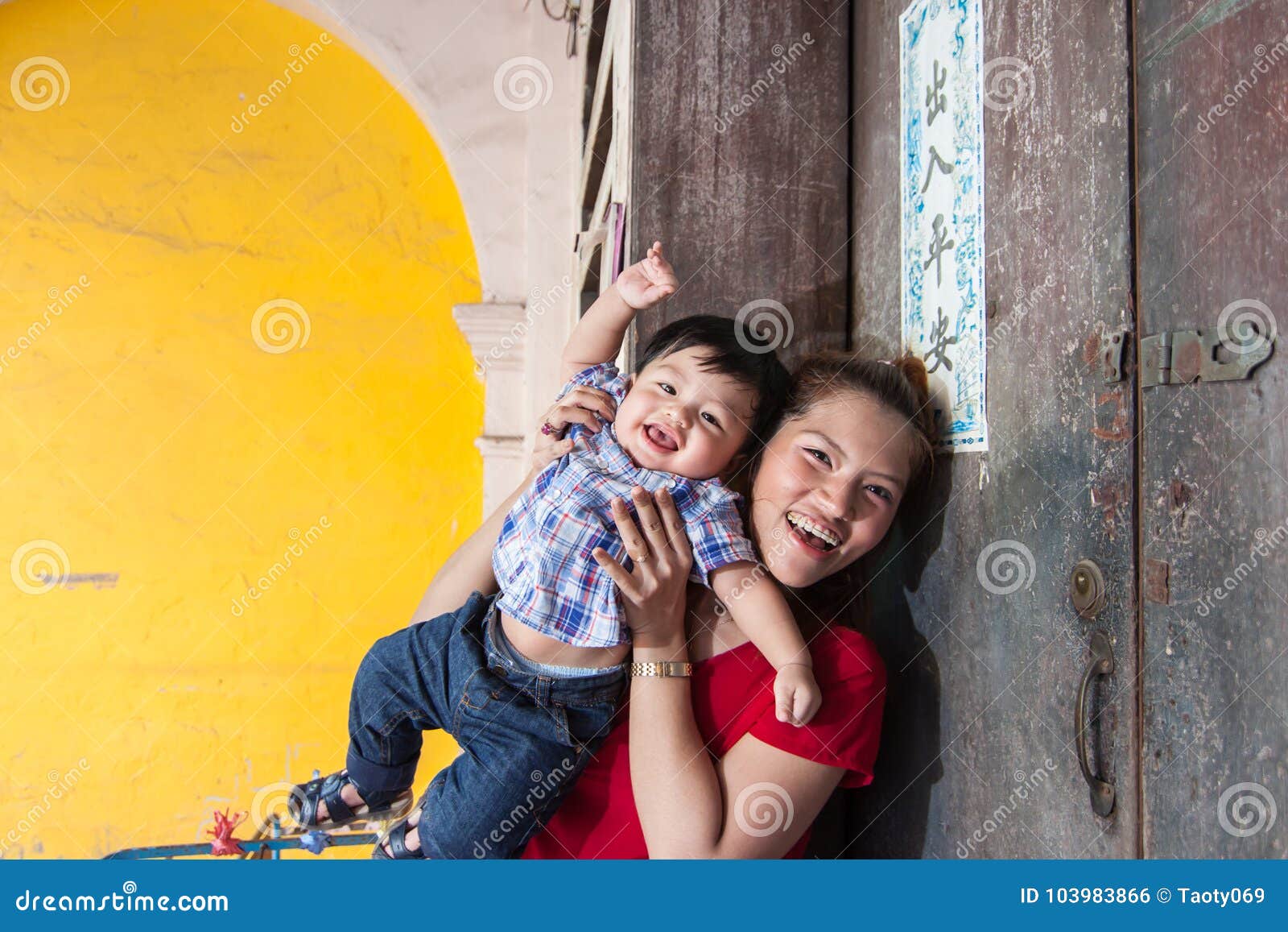 mother and son standing at the house