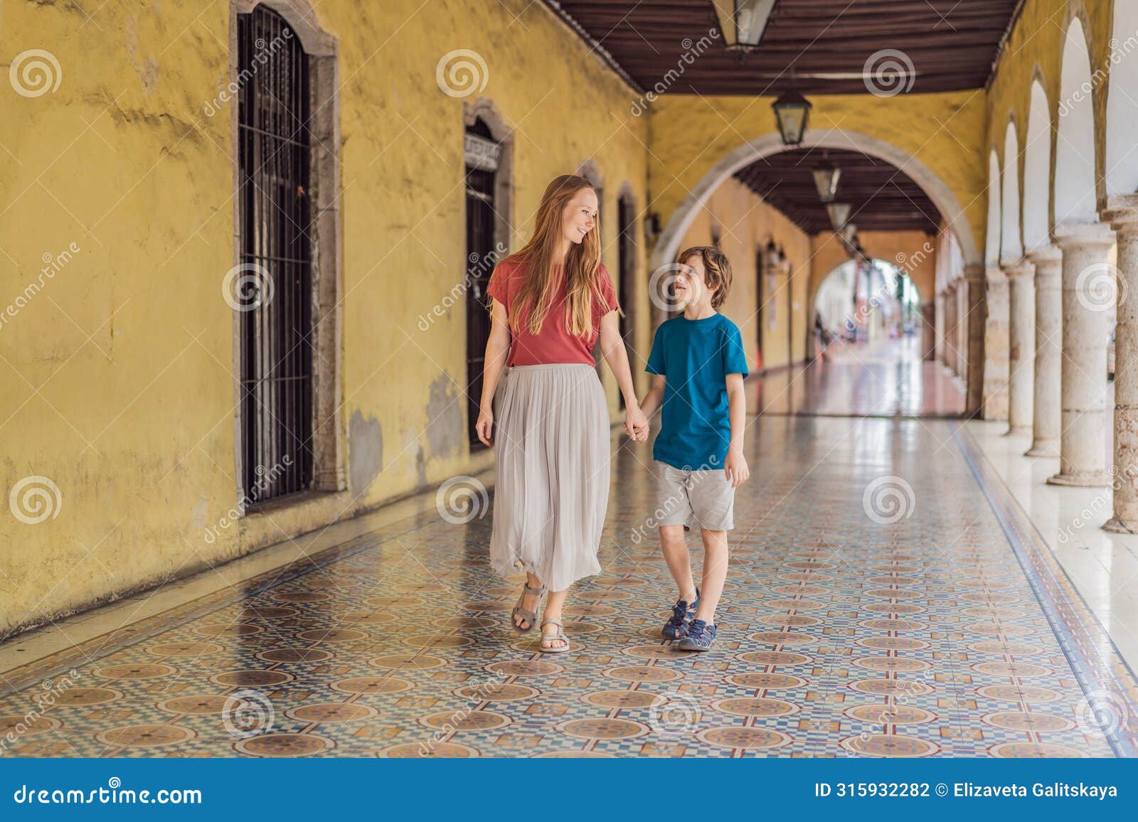 mother and son tourists explore the vibrant streets of valladolid, mexico, immersing herself in the rich culture and
