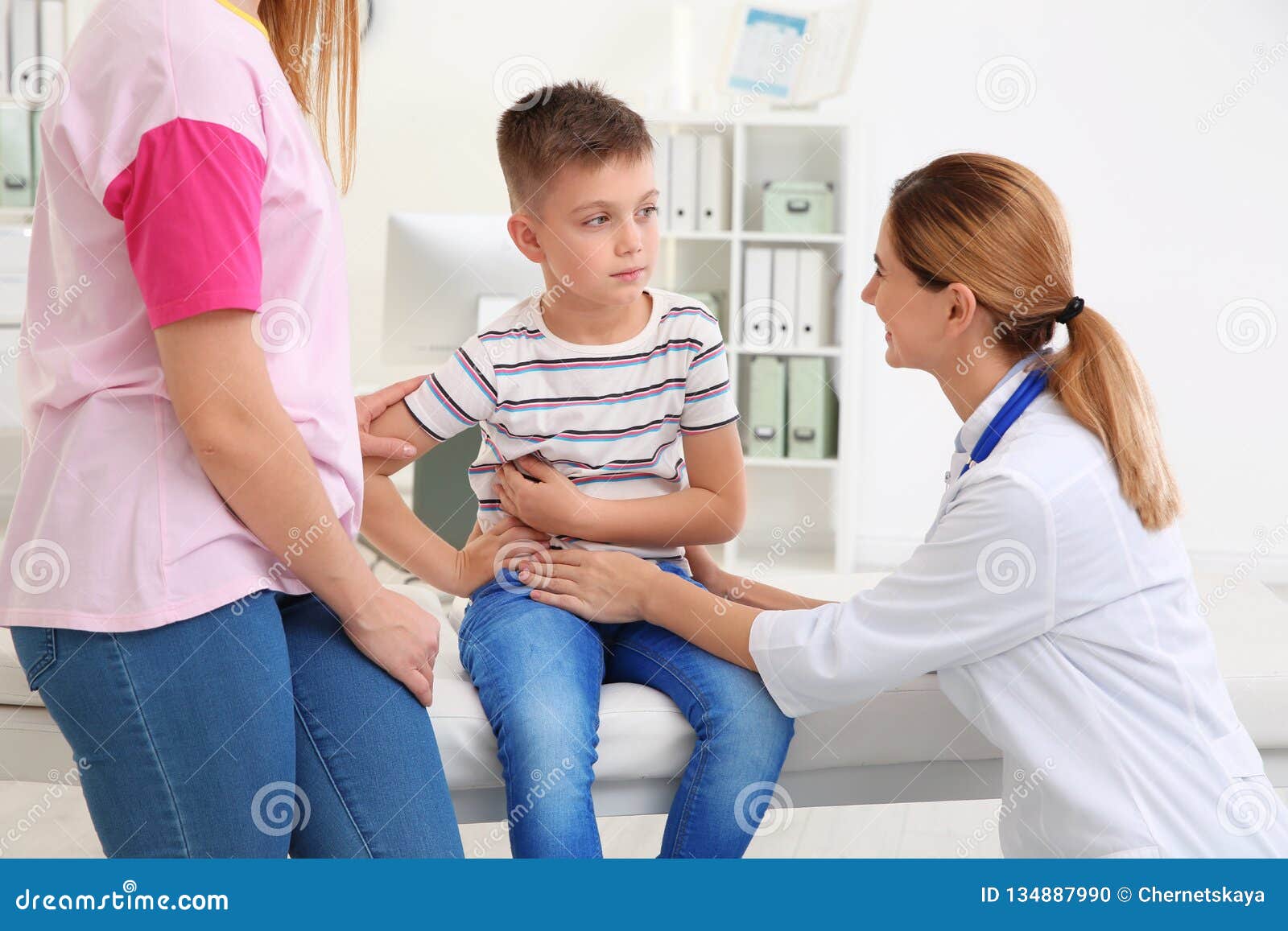 Mother and son visiting pediatrician. Doctor working with patient in hospital