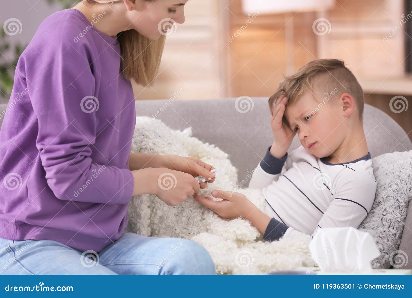 Mother Taking Care Of Little Son Suffering From Cold Stock Image