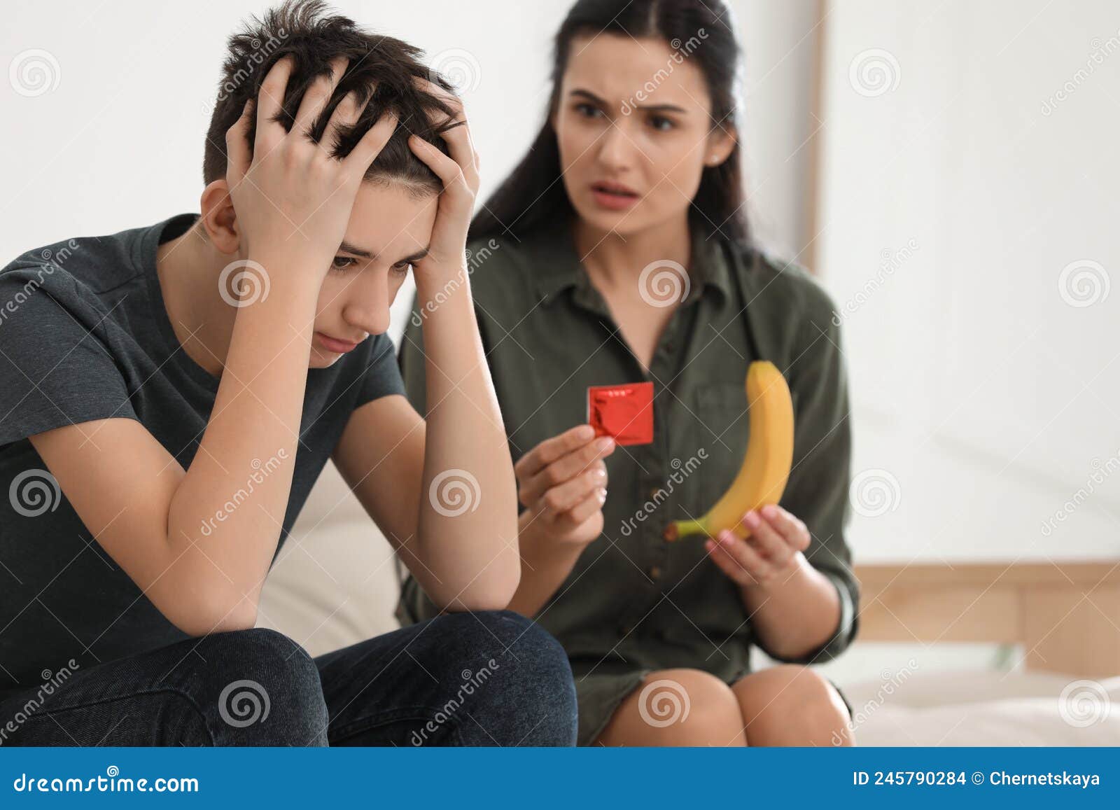 Mother Talking with Her Teenage Son about Contraception at Home picture photo