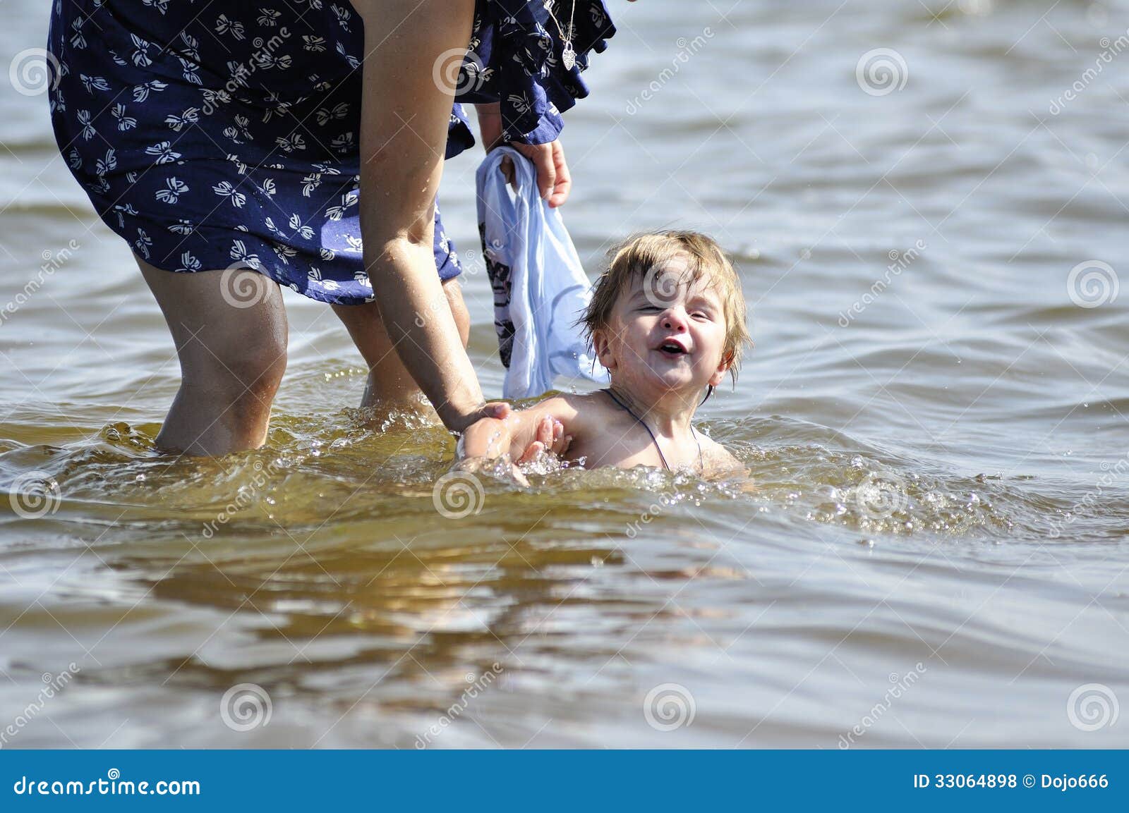 Mother Teaches the Kid To Swim for the First Time Stock Photo Image