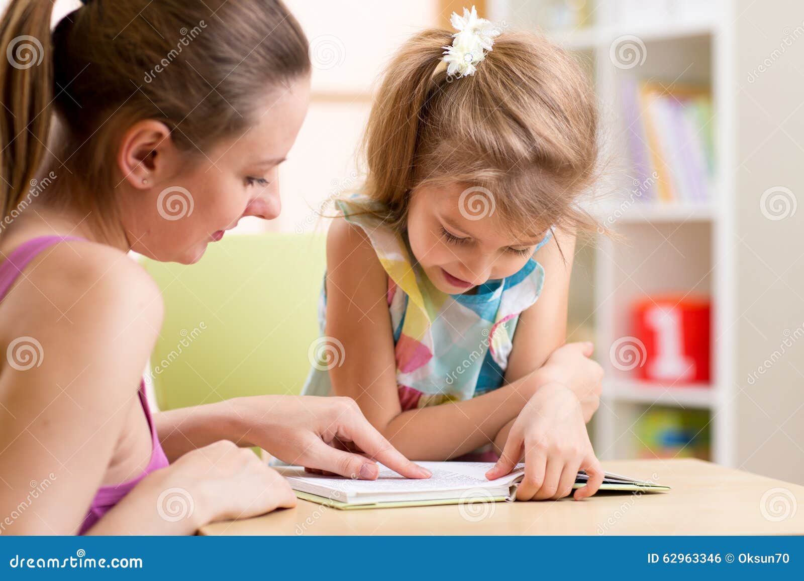 mother teaching child daughter to read