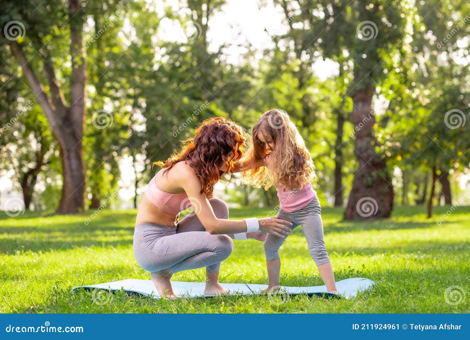 Mother Teaching Her Small Daughter Yoga In The Park At Daytime Stock Image Image Of Adult