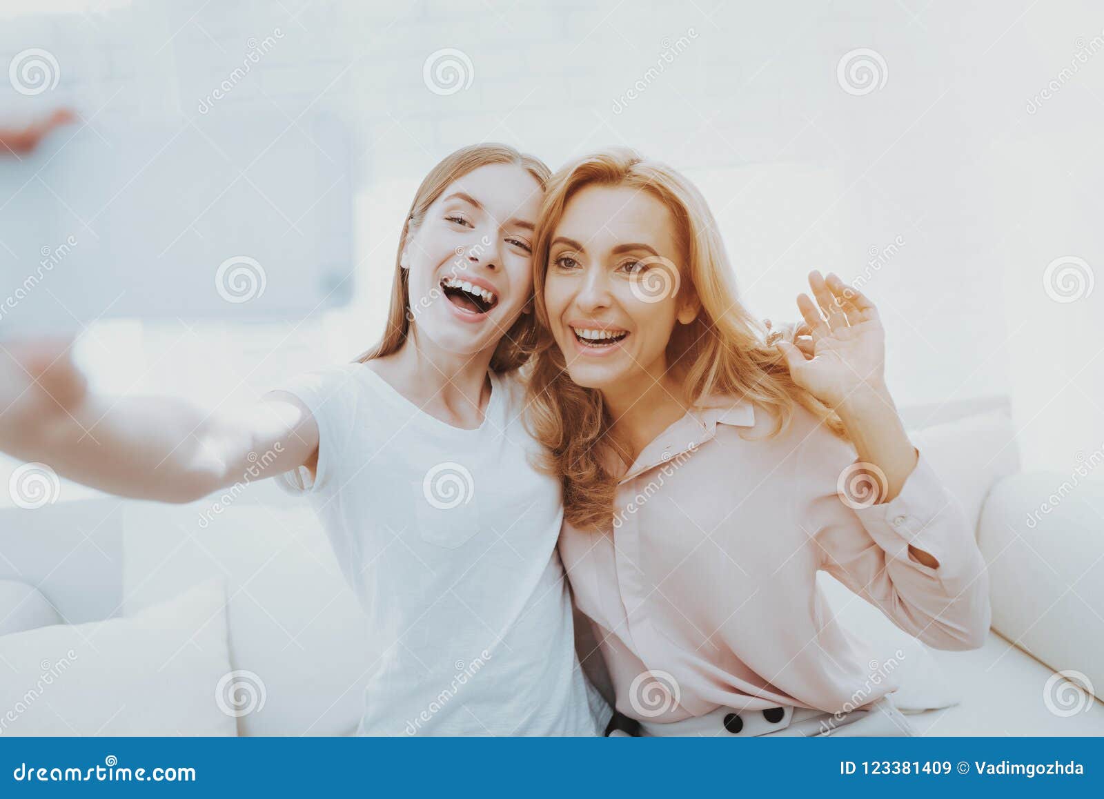 Mother and Teenage Daughter Taking Selfie on Sofa. Stock Image - Image ...