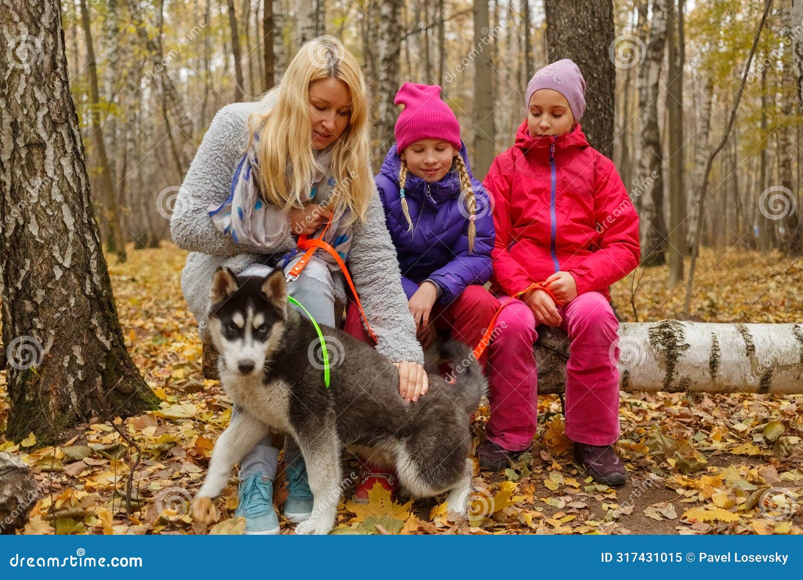 mother and two daughters with dog breed husky