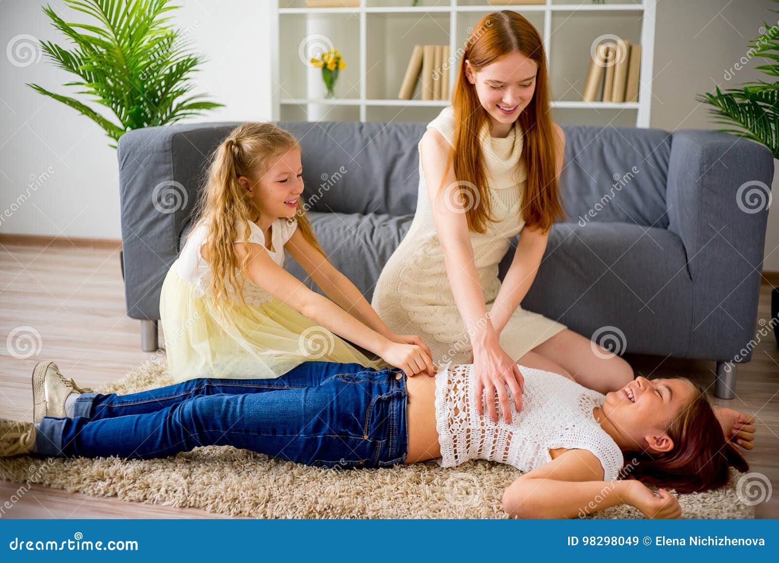 Mother And Two Daughters Playing And Tickling Stock Image Image O