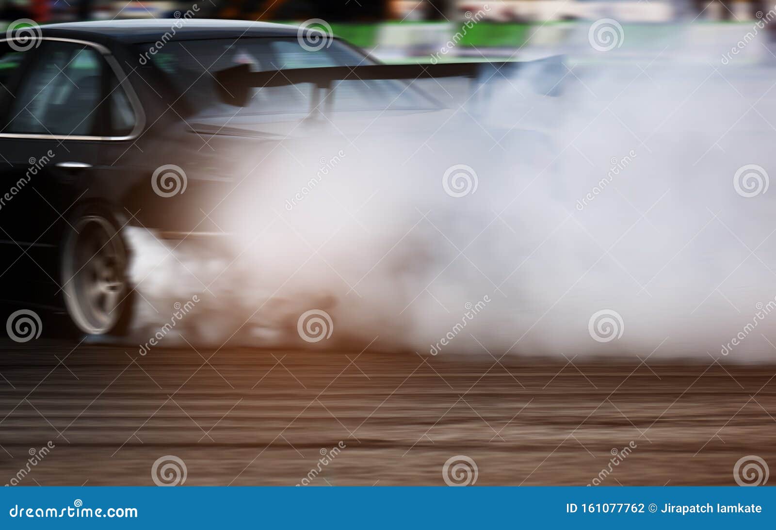 Car drifting, Blurred of image diffusion race drift car with lots of smoke  from burning tires on speed track Stock Photo