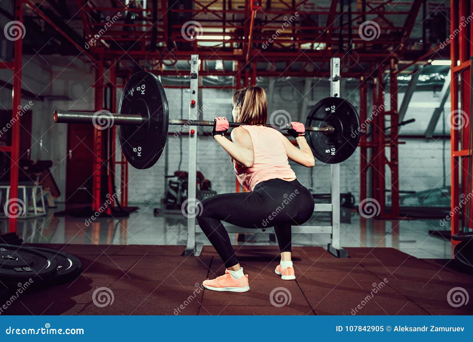 Gorgeous Young Fitness Woman Crouch and Doing Squad Exercise with a Bar ...