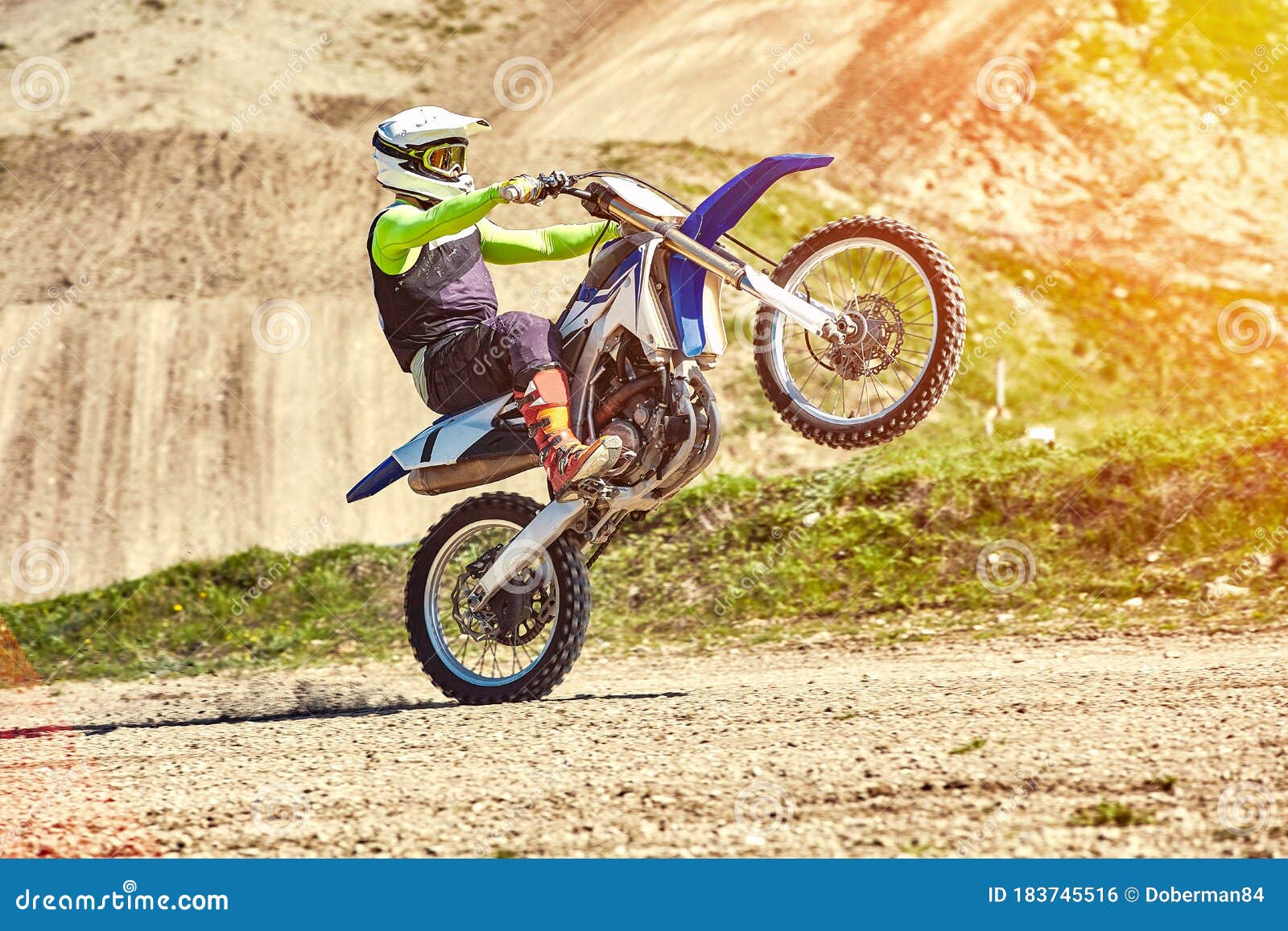 Motocross, A Rider Stands On The Rear Wheel Of A Bike, Riding On The Rear  Wheel. Extreme, Industrial, Motorcycle Cross Stock Photo - Image of  freestyle, enduro: 183745516