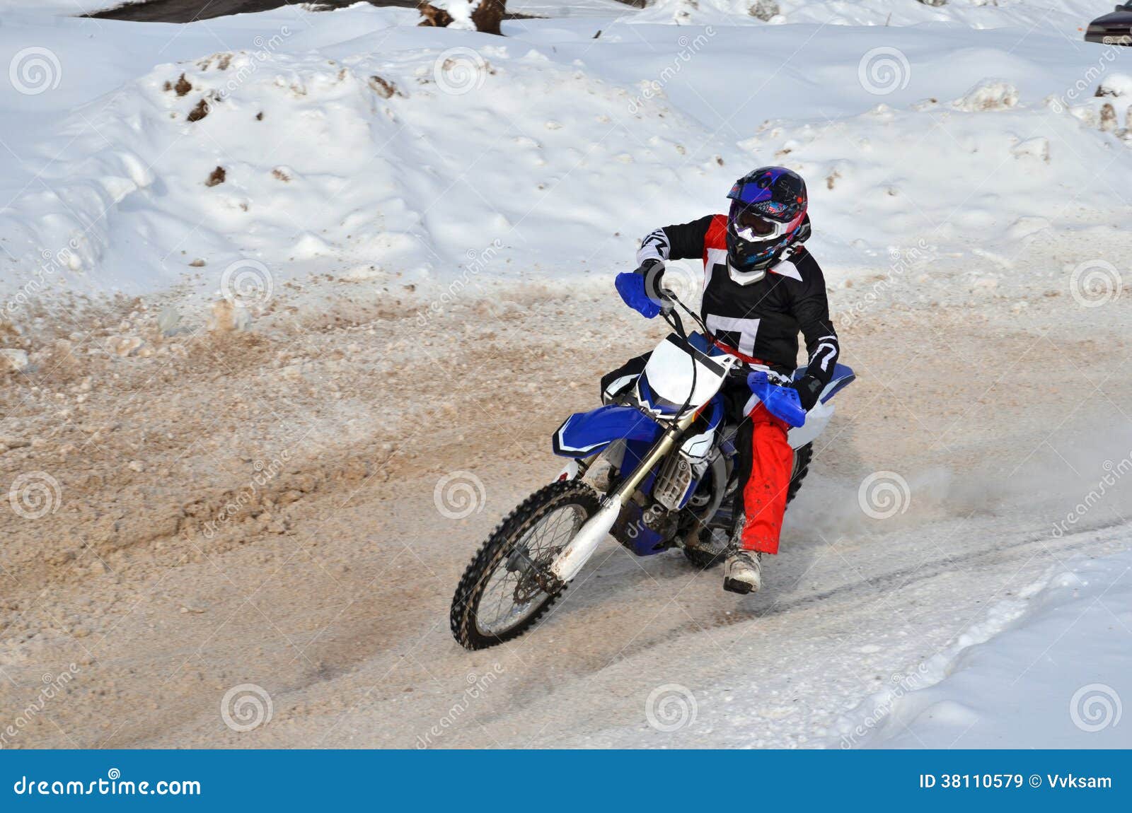 Motocross on Snow Racer on a Motorcycle in the Left Turn Having Stock
