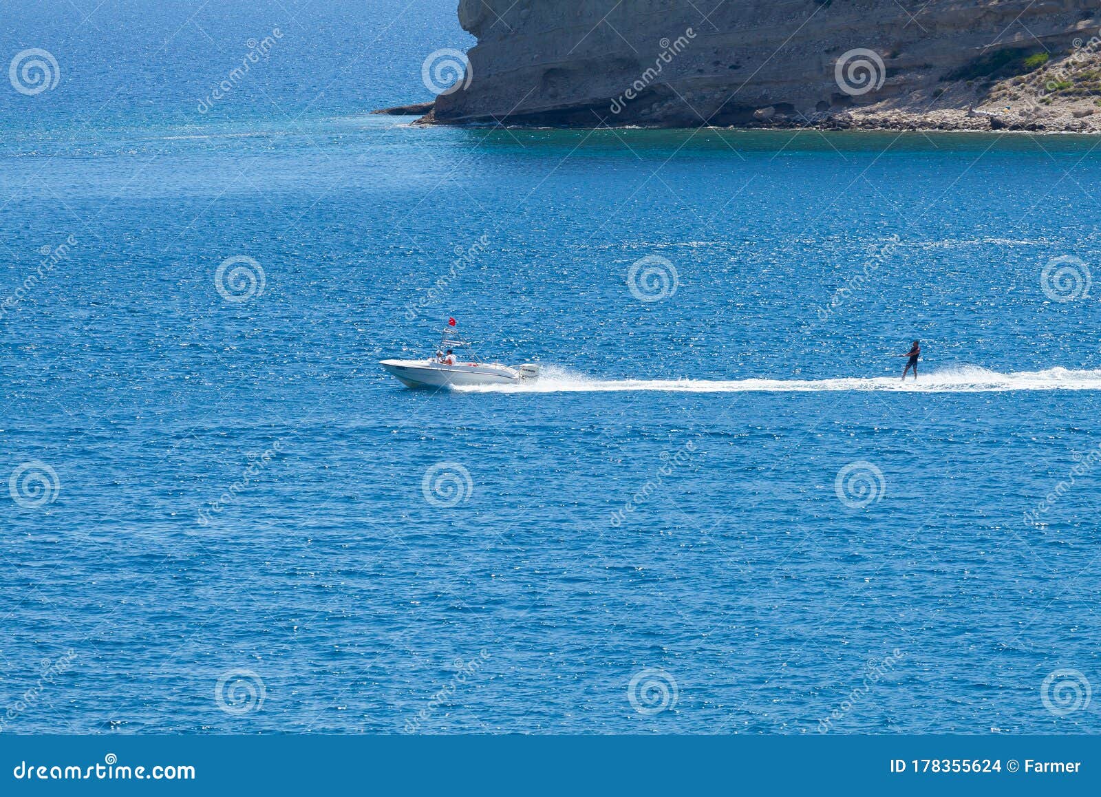 Motor Boat Pulls a Man on a Board on a Cable Editorial Stock Image