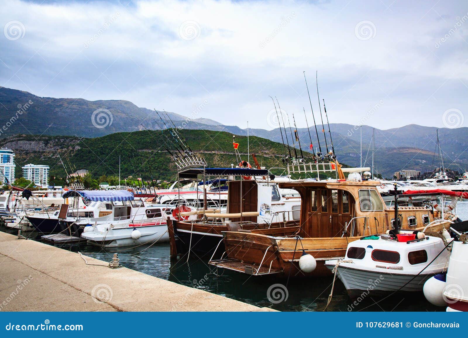 Motor Boats and Sailboats Docked in Harbor Against Mountains. Fishing ...