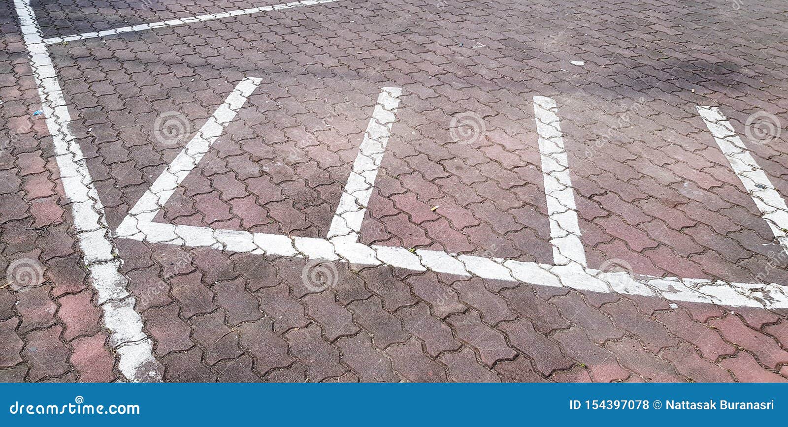 Motorcycle Or Car Parking With White Painted Line On Brown Brick
