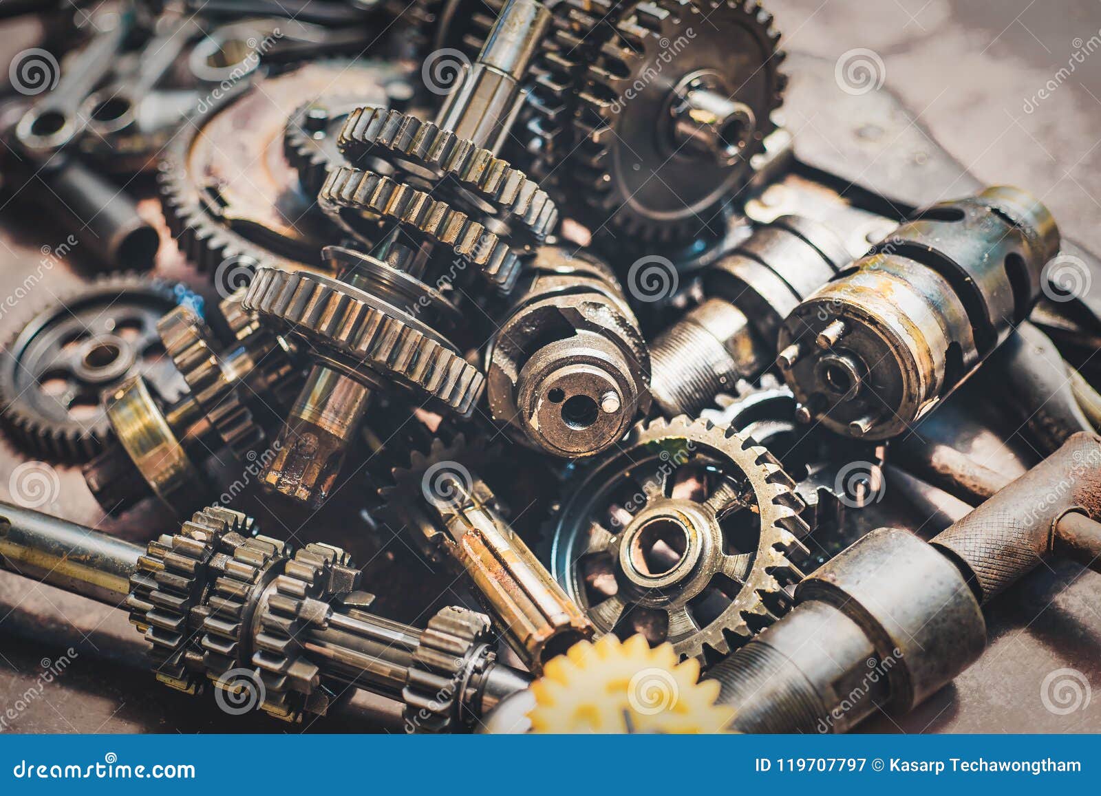 motorcycle engine part , old transmission gears on rusty background . selective focus