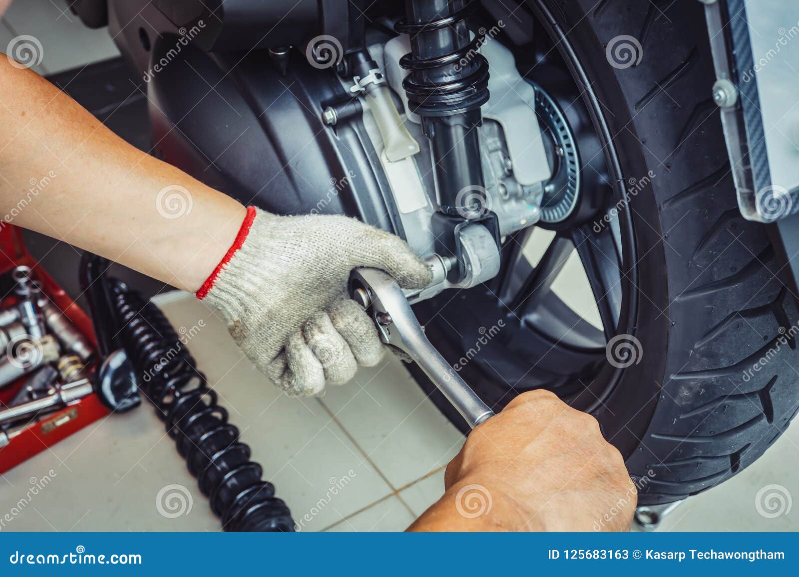 Motorcycle Mechanic Using Impact Wrench Socket Replace Rear Shock