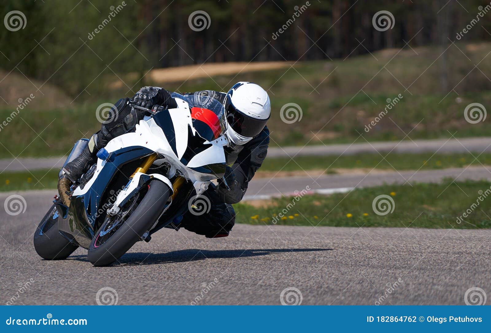 Motorcycle Practice Leaning into a Fast Corner on Track Stock Photo
