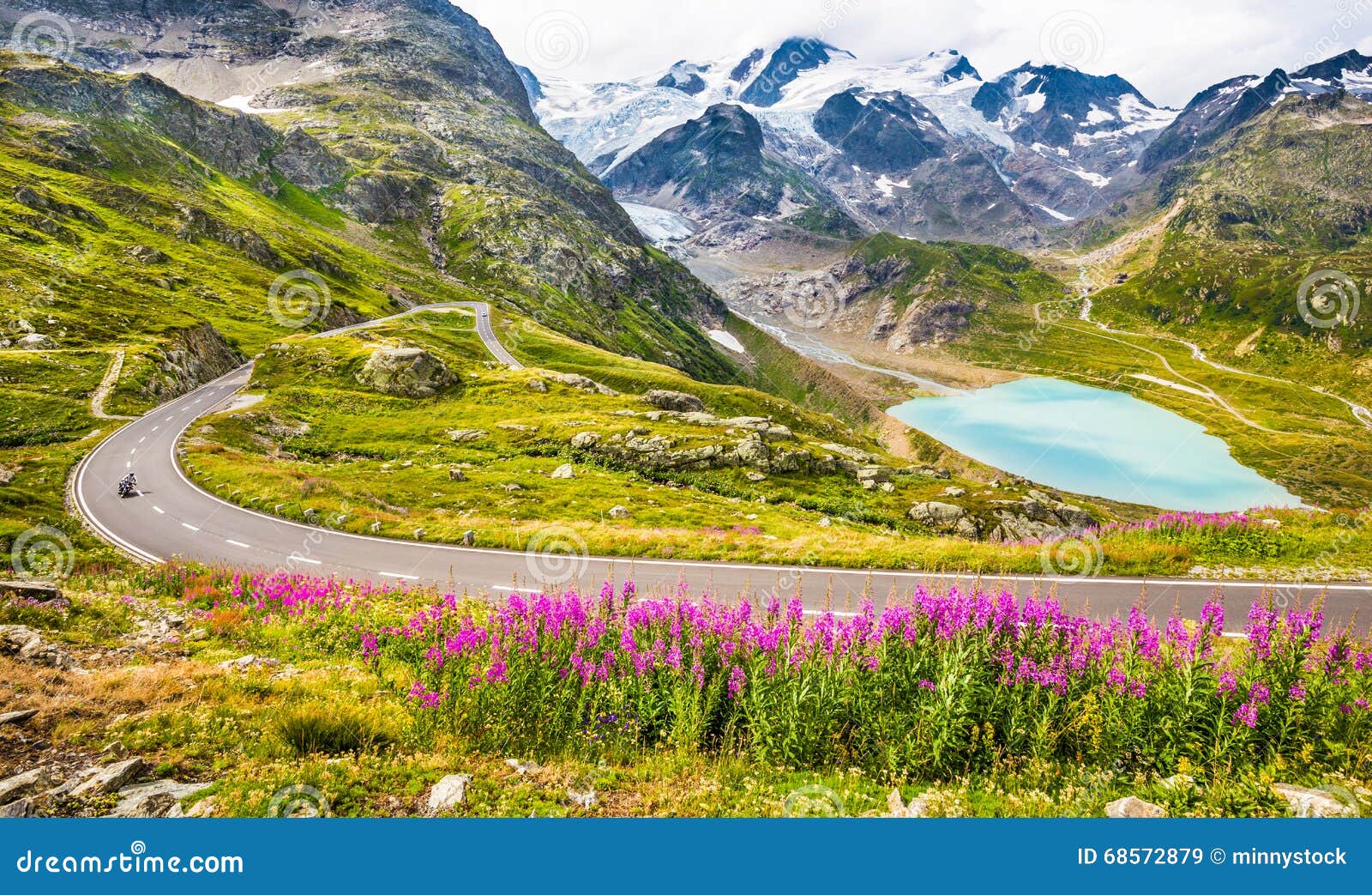 motorcyclist on mountain pass road in the alps