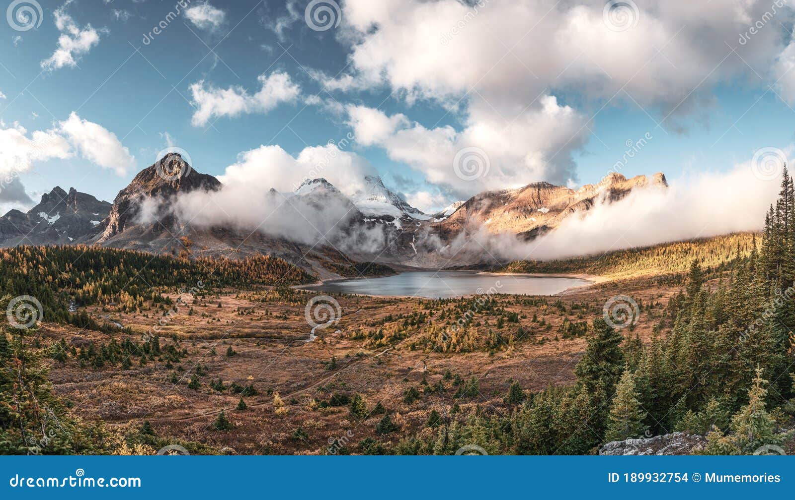 Mount Assiniboine With Blue Sky On Lake Magog In Autumn Forest At