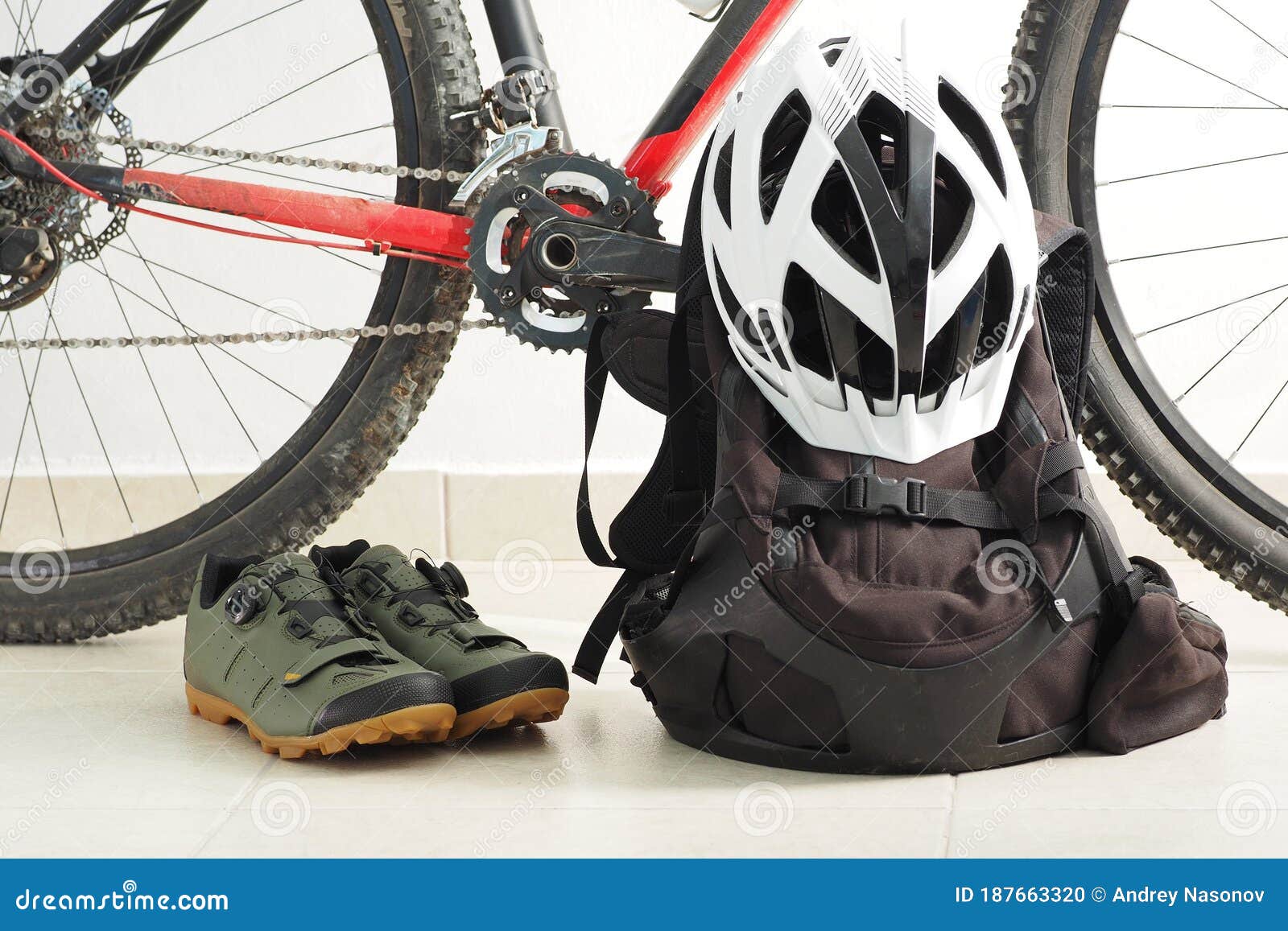 mountain bike, velo shoes, backpack and white helmet.