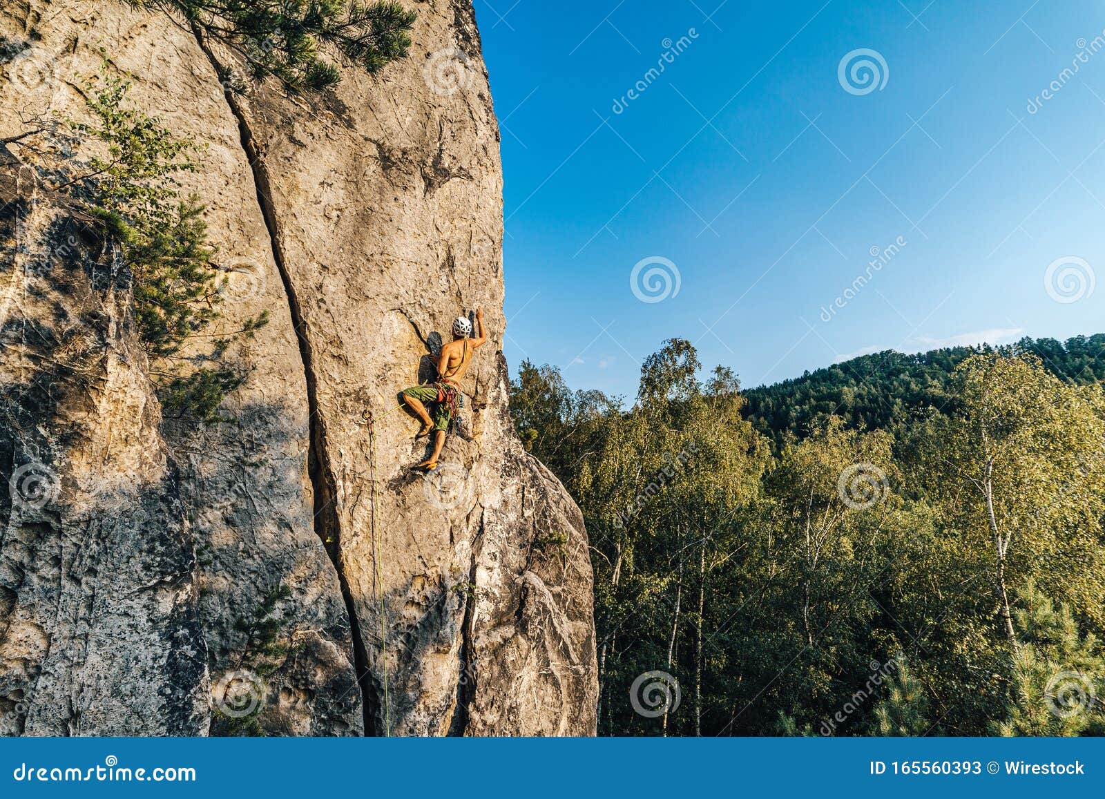 Mountain Climber Climbing the Cliff Using His Climbing Equipment