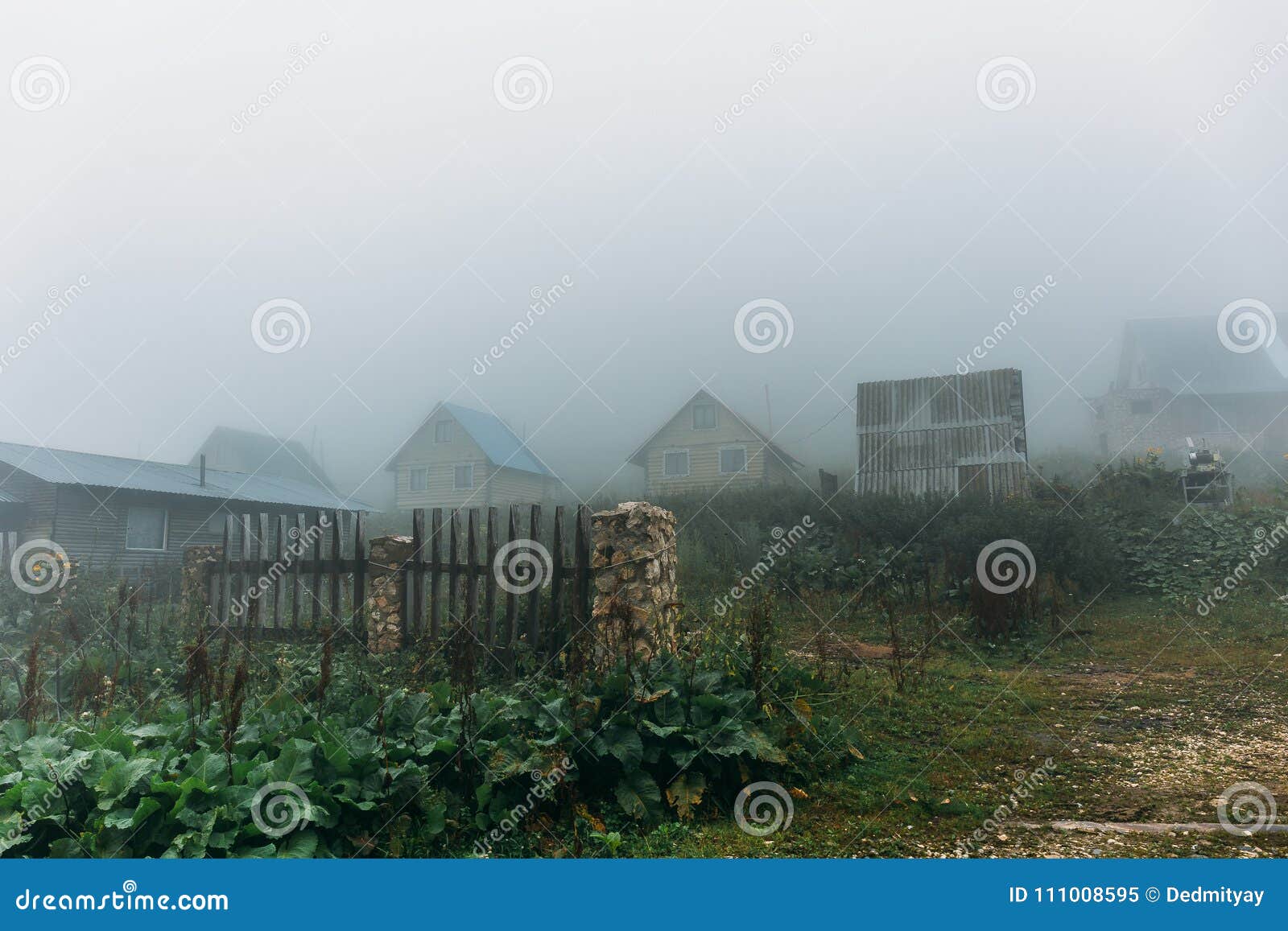 Mountain Countryside with Small Houses and Fog in Morning Fog or Mist ...