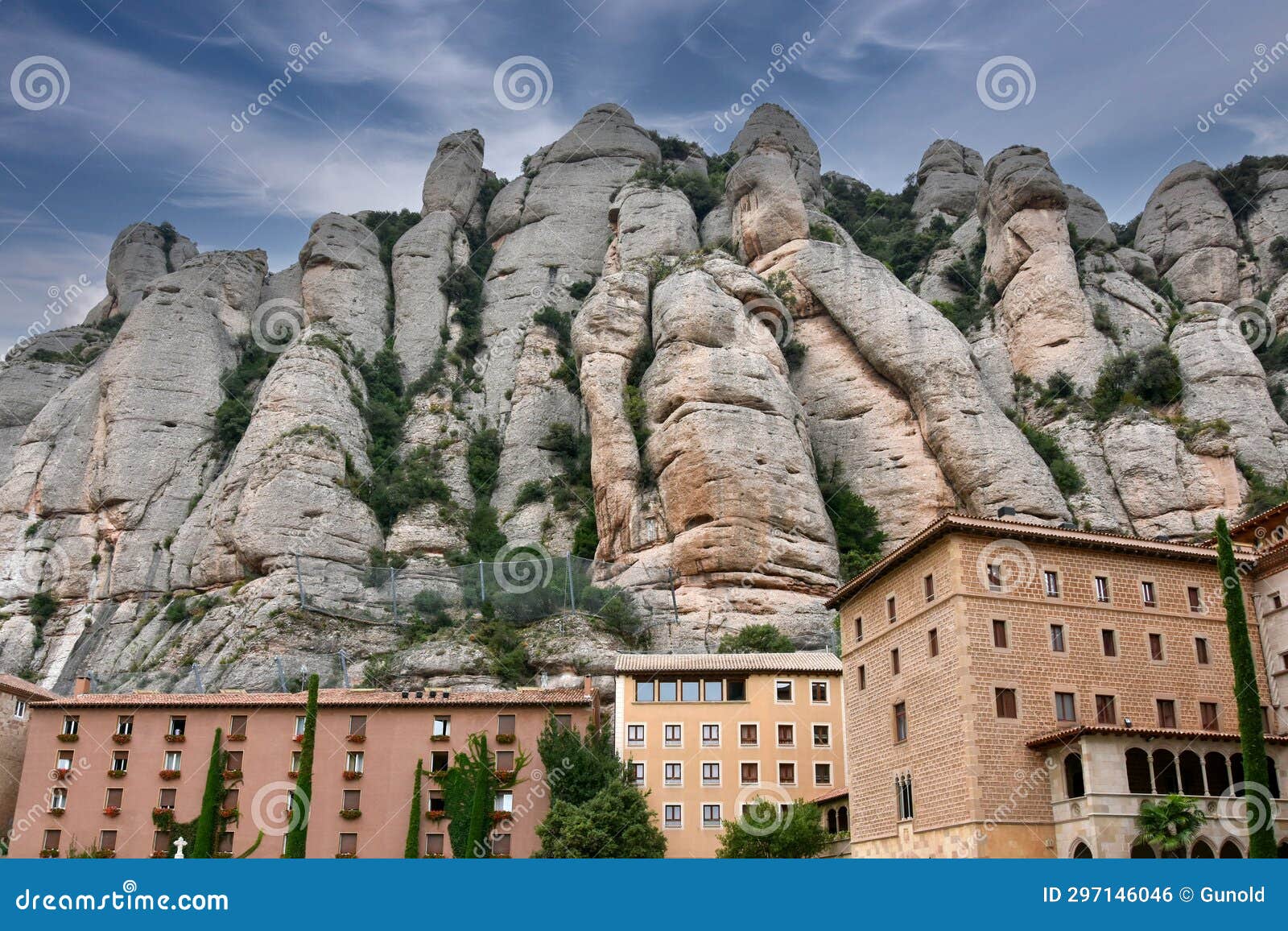 mountain formations and abbey of montserrat at a dark cloudy day