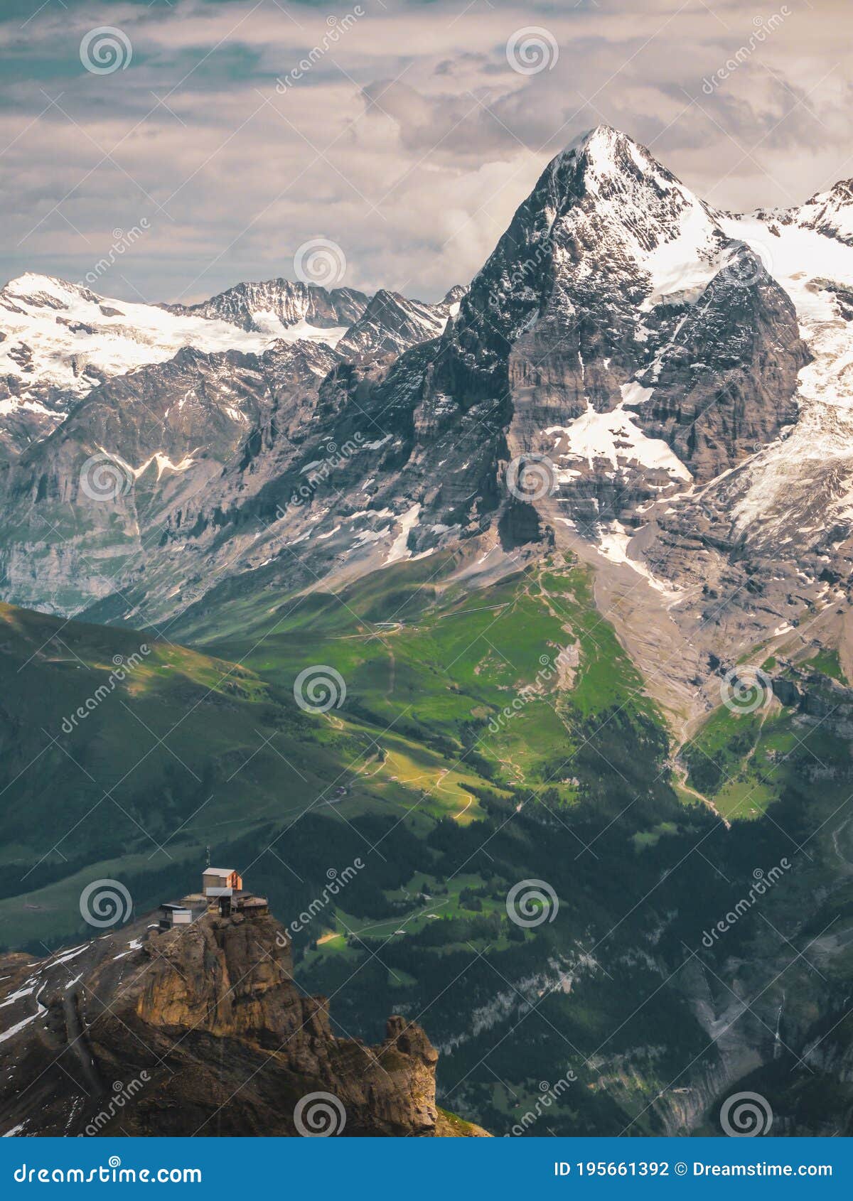 A Mountain Hut At The Edge Of A Cliff With A Green Valley Below And