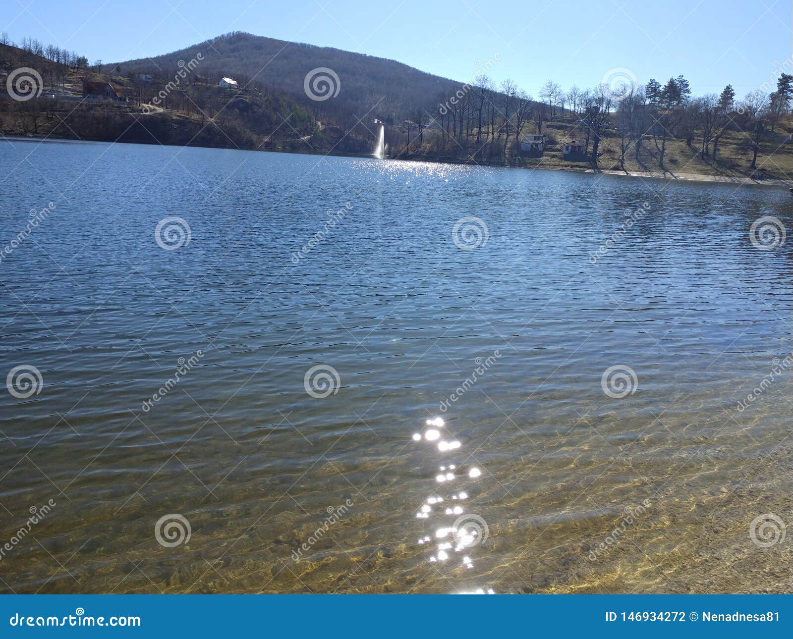 mountain lake and fontain view from a shore