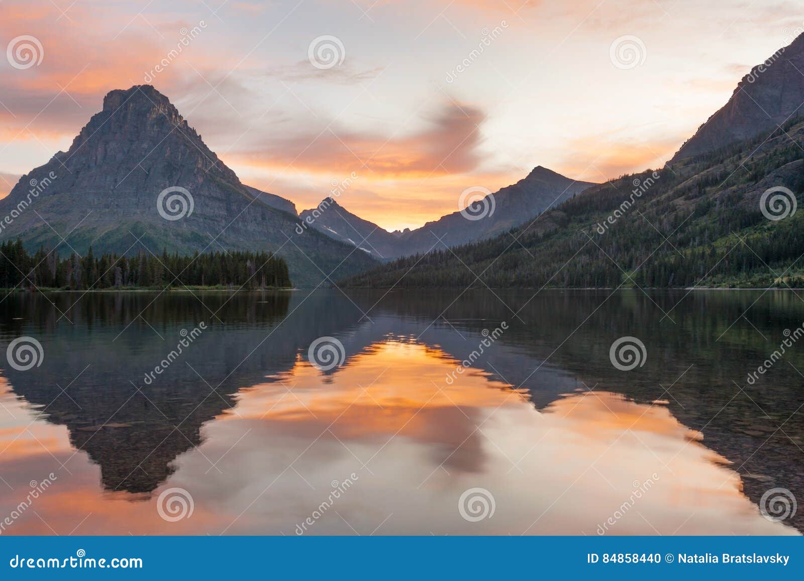 sunrise over two medicine lake in glacier national park, montana
